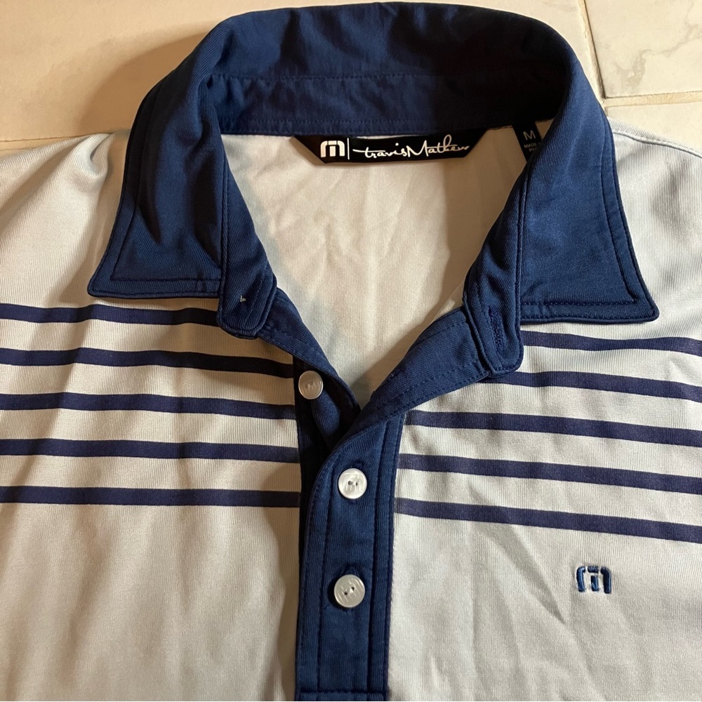Travis Mathew light blue / Navy Polo / golf shirt.  Short sleeve.